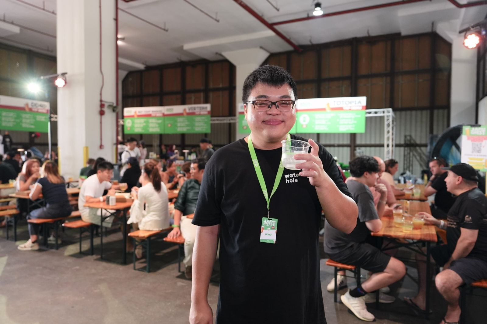 A guest raises a drink at HopFest